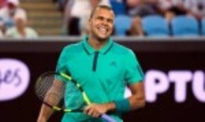 Jo-Wilfried Tsonga grins after beating Pierre-Hugues Herbert to reach the Australian Open last 16