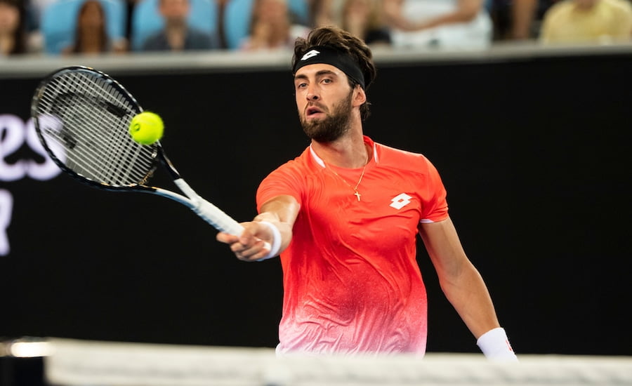 Nikoloz Basiliashvili plays a forehand volley at the Australian Open