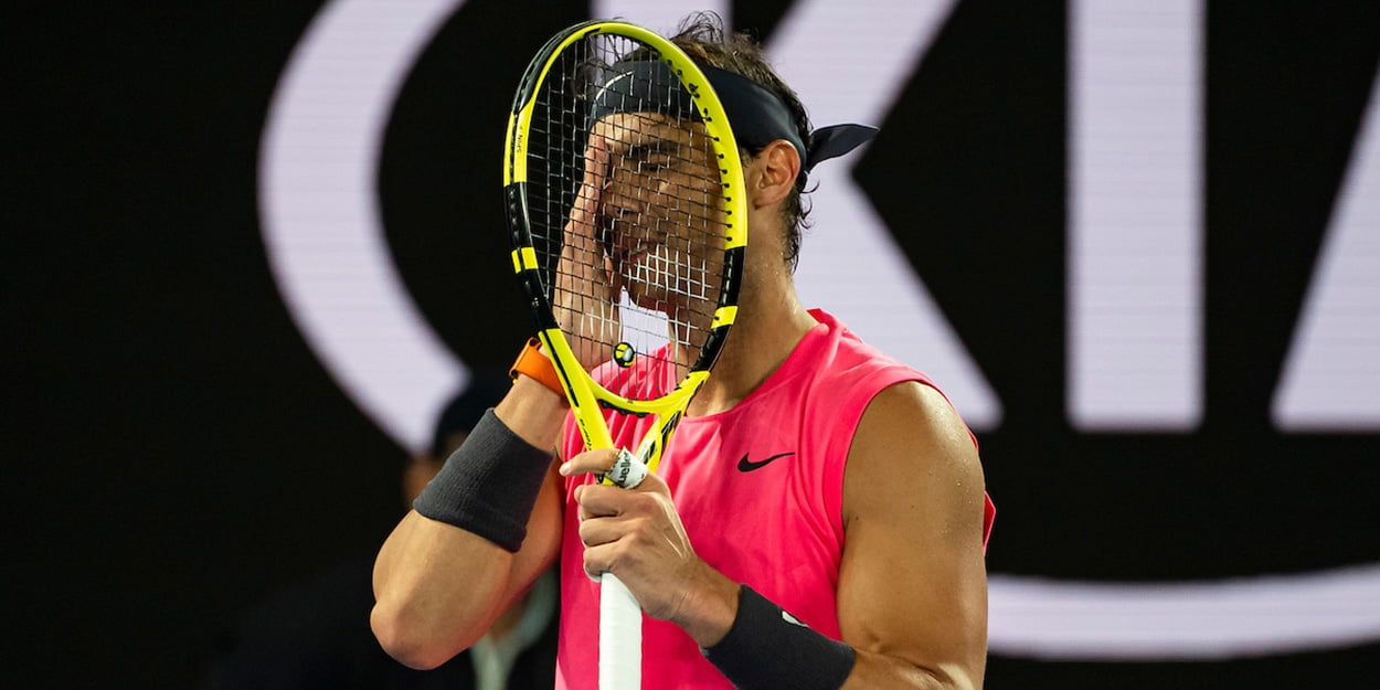 Rafael Nadal hiding behind racket