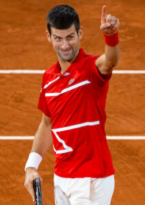 Djokovic gestures to the small crowd at the French Open