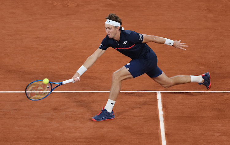 Casper Rudd stretches for a forehand at Roland Garros